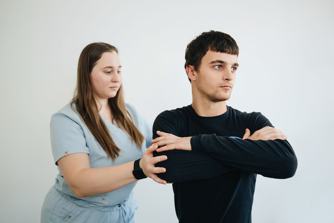Physiotherapist guiding a patient through a shoulder stretch
